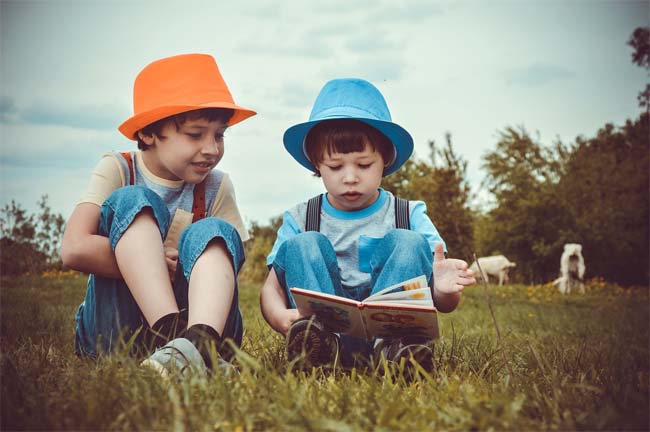 Child Reading to Another