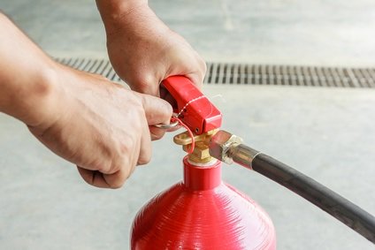 Pulling Out Pin on Fire Extinguisher