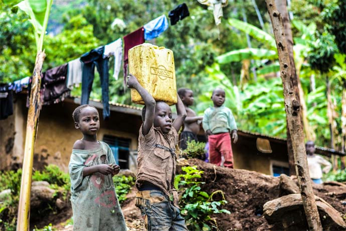 Ugandan Boy Carrying a Can